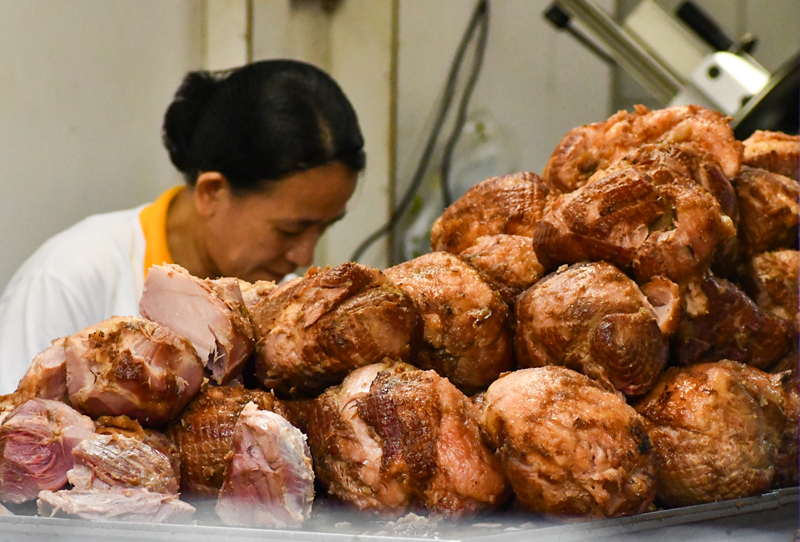 Storekeeper prepares cuts of ham for buyers at a popular ham store in Quiapo, Manila. Norman Cruz